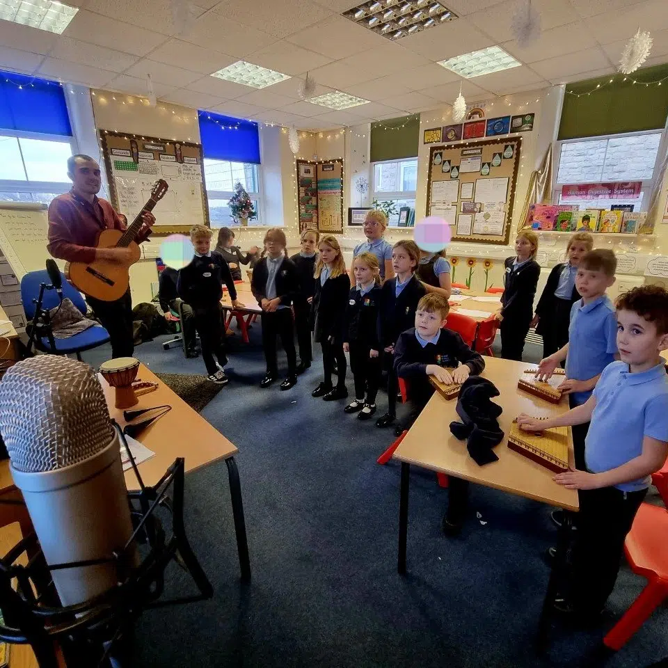 Henry at school workshop playing guitar