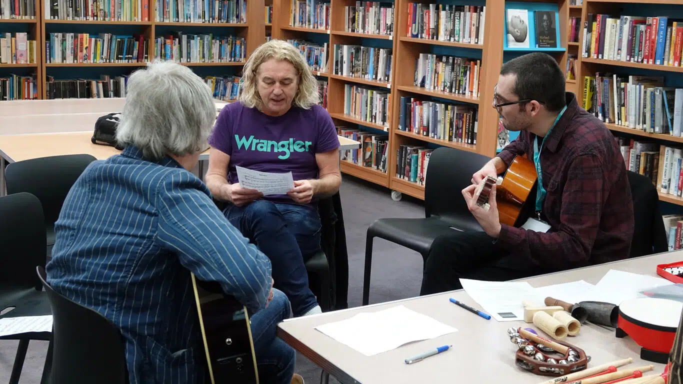 Henry at school workshop playing guitar