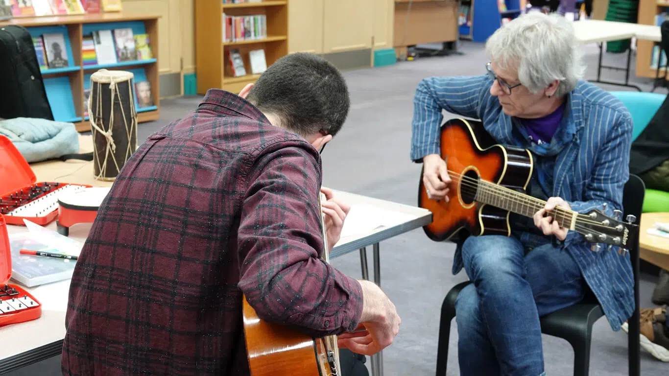 Henry at school workshop playing guitar