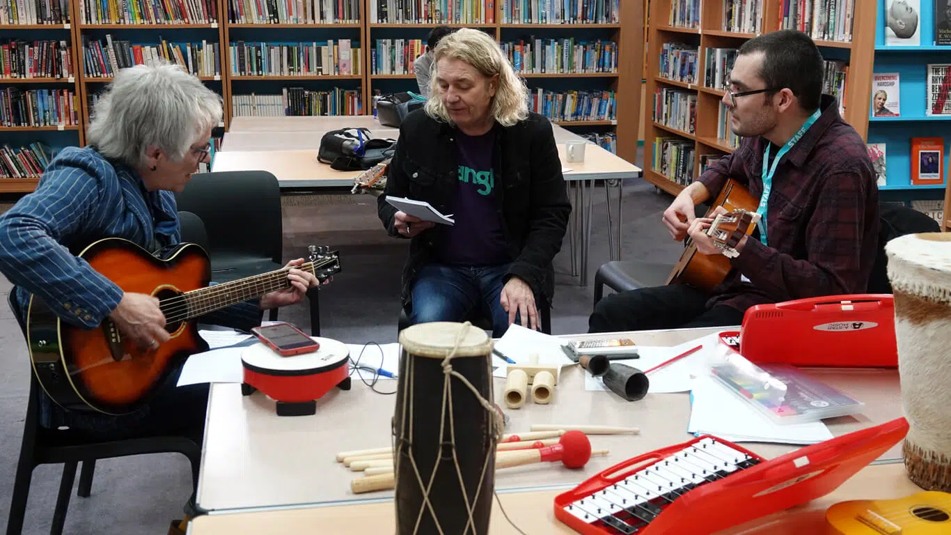 Henry at school workshop playing guitar